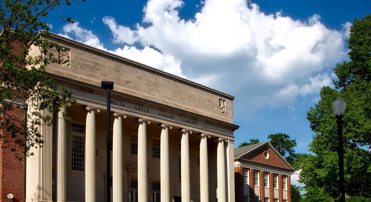 Sunlit campus library with white columns and the name Amelia Gayle Gorgas Library carved in the stone.